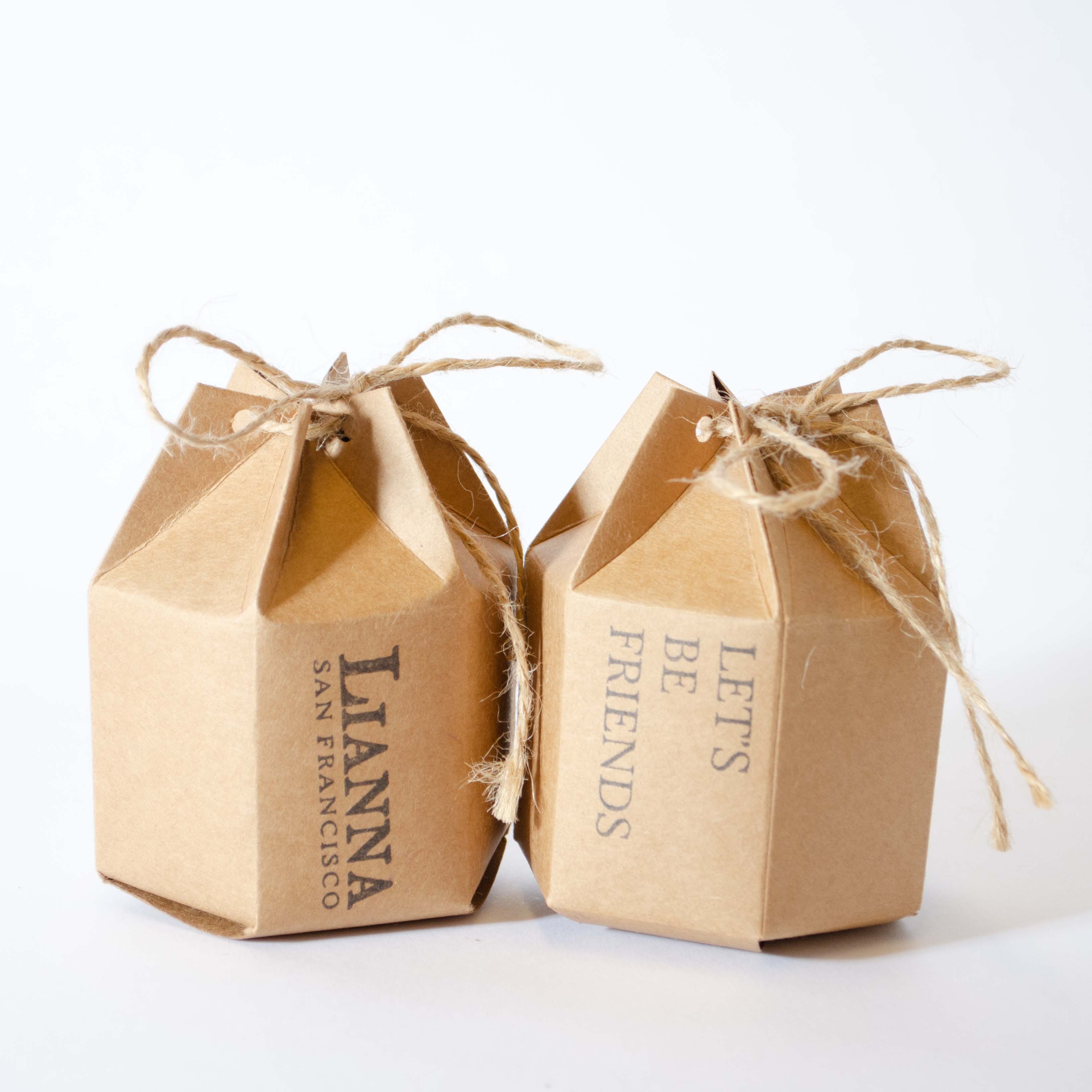 Hexagon kraft gift box with a twine bow closure. Stamped with Lianna San Francisco