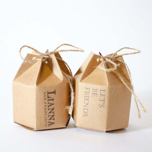 Hexagon kraft gift box with a twine bow closure. Stamped with Lianna San Francisco