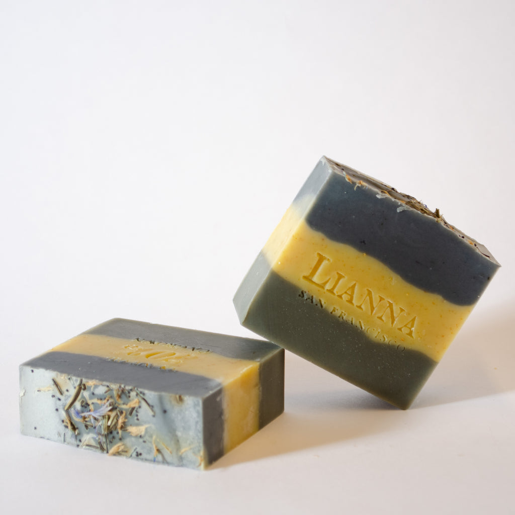 California olive oil soap with three natural colored layers scented with earthy essential oils and stamped.