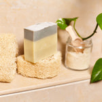 Ladda upp bild till gallerivisning, Olive oil soap on a loofah sponge in the shower with a jar of scrub.
