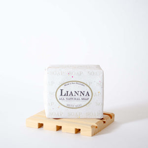 Bar of winter night olive oil soap wrapped in tree free biodegradable paper packaging. Packaging reads Lianna, all natural soap.